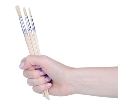 Paint brushes in hand Stock Photos