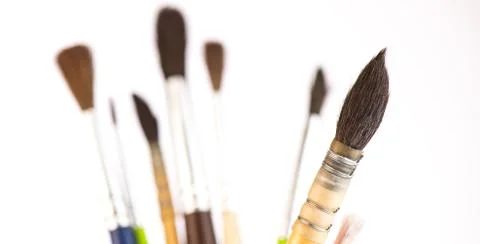 Paint brushes in a jar on whith background Foto stock