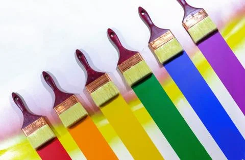 Paint brushes with multi-colored samples of paints. Stock Photos