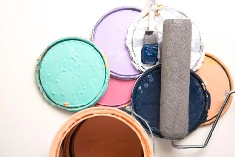Paint can and lids with roller and brush Stock Photos