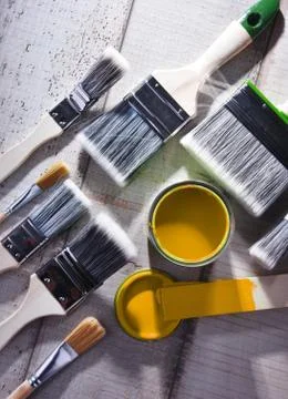 Paint can and paintbrushes of different size  for home decorating purposes. Stock Photos