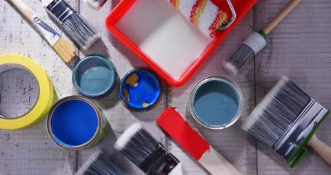 Paint can and paintbrushes of different size  for home decorating purposes. Stock Photos
