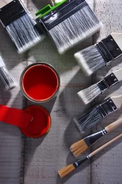 Paint can and paintbrushes of different size  for home decorating purposes. Stock Photos