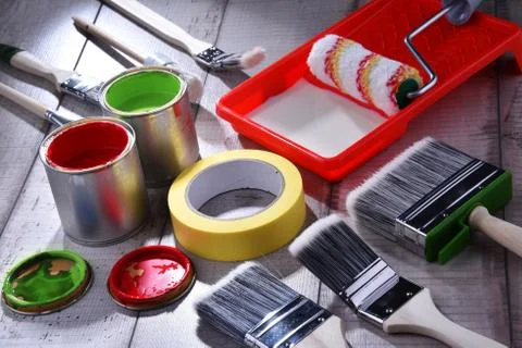 Paint can and paintbrushes of different size  for home decorating purposes. Stock Photos