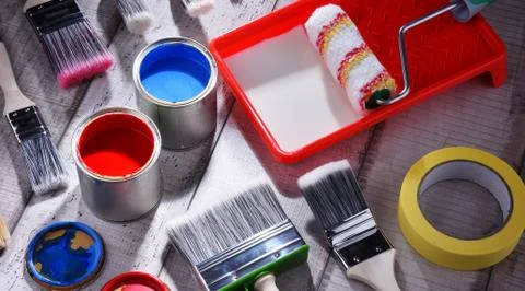 Paint can and paintbrushes of different size  for home decorating purposes. Stock Photos