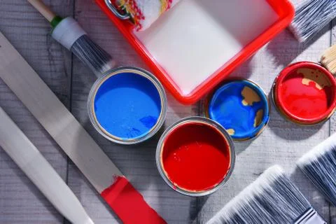 Paint can and paintbrushes of different size  for home decorating purposes. Stock Photos
