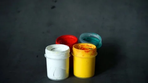 Paint can. colored cans with paint on black background. Stock Footage 99237690