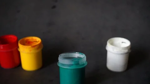 Paint can. colored cans with paint on black background. Stock Footage 99237691