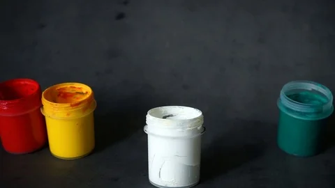 Paint can. colored cans with paint on black background. Stock Footage 99237693