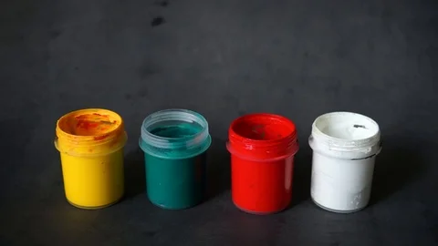 Paint can. colored cans with paint on black background. Stock Footage 99237696