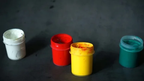 Paint can. colored cans with paint on black background. Stock Footage 99237699