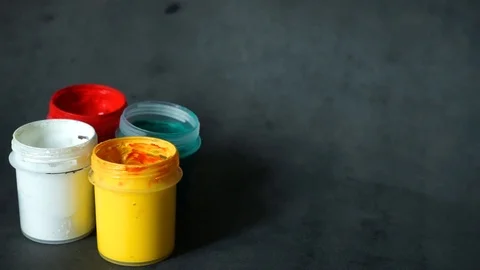 Paint can. colored cans with paint on black background. Stock Footage 99237703