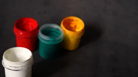 Paint can. colored cans with paint on black background. Stock Footage 99237706