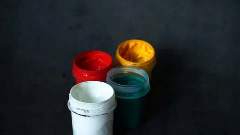 Paint can. colored cans with paint on black background. Stock Footage 99237708