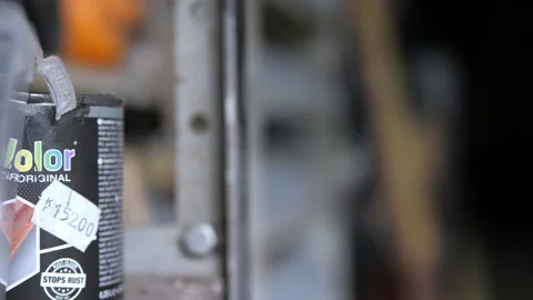 Paint can on garage shelf with things in the background Stock Footage 195982104