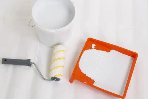 Paint can, roller and paint tray for painting wall on the floor Stock Photos