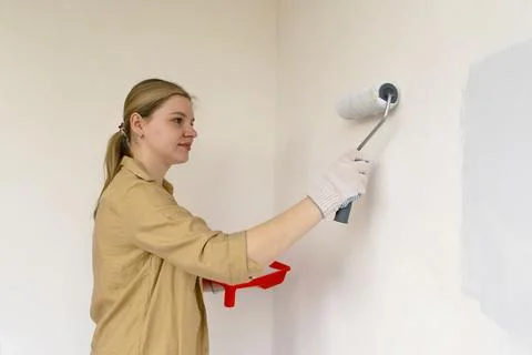Paint can, roller and paint tray for painting wall. Stock Photos