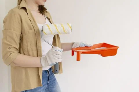 Paint can, roller and paint tray for painting wall on the floor Stock Photos