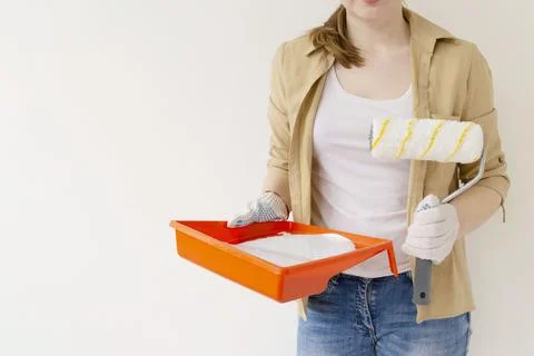 Paint can, roller and paint tray for painting wall on the floor Stock Photos