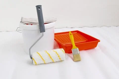 Paint can, roller and paint tray for painting wall on the floor Stock Photos