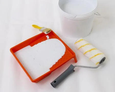 Paint can, roller and paint tray for painting wall on the floor Stock Photos