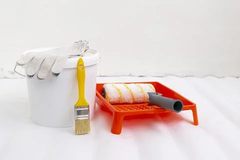 Paint can, roller and paint tray for painting wall on the floor Stock Photos