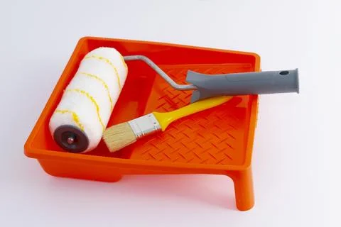 Paint can, roller and paint tray for painting wall on the floor Stock Photos
