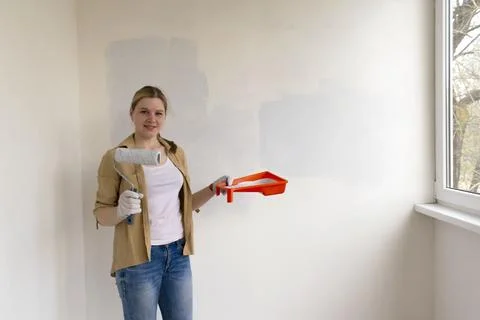 Paint can, roller and paint tray for painting wall. Stock Photos