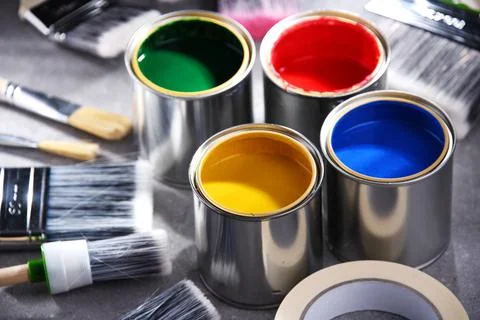 Paint cans and paintbrushes of different size  for home decorating purposes. Stock Photos