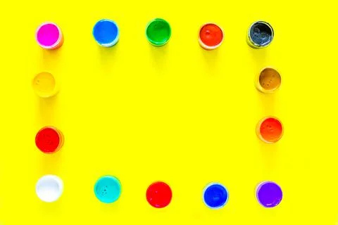 The paint cans are arranged in rectangles along the edge of the photo Stock Photos