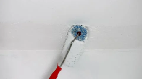 To paint the ceiling with white paint use a paint roller Stockbeeldmateriaal 236459547