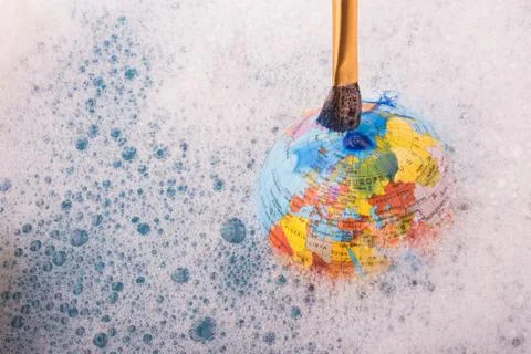 Paint dissolving on the top of globe Foto stock