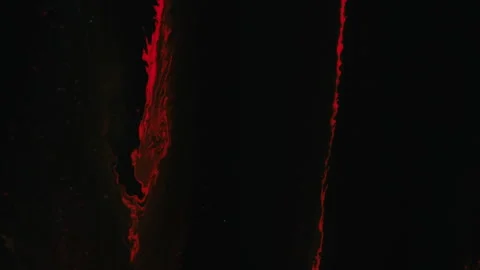 Paint drip ink pouring red dye spill flow on black Stock Footage 253892461