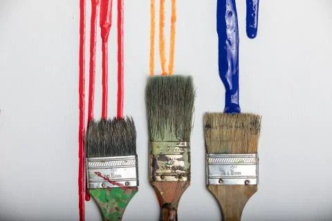 Paint dripping onto paint brushes background texture Stock Photos