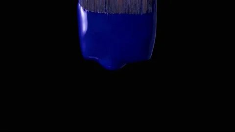 Paint drips from the brush on a black background 動画素材 170160924