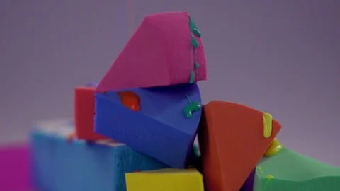 The paint drips onto the sponge and drains over them. Stock Footage 77512097