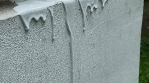Paint drips on a white wall outside Stock Footage 306153130
