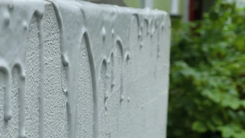 Paint drips on a white wall outside Stock Footage 306153189