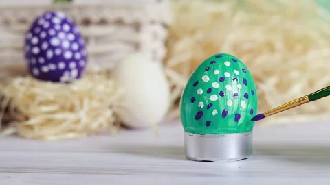 Paint the Easter egg with a brush, put dots Stock Footage 233095863