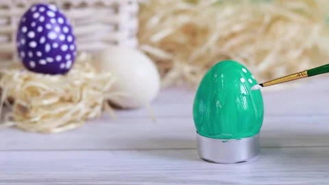 Paint the Easter egg with a brush, put dots Stock Footage 233286846