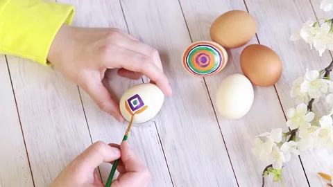 Paint Easter eggs with bright colors, top view. Master class on painting eggs Stock Footage 234123410