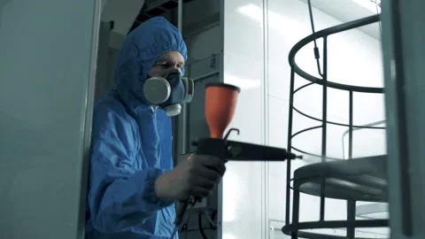 The paint engineer applies an even coat of paint to the metal frame Stock Footage 179714401