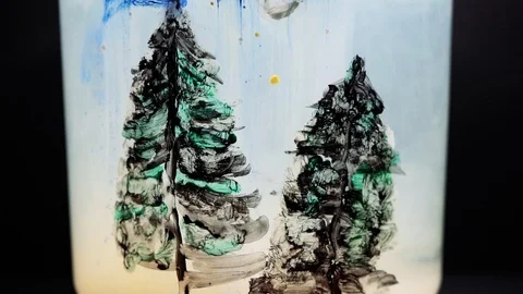 Paint floating in water tank with pine trees drawing inside. Stable shot Video stock 127279119
