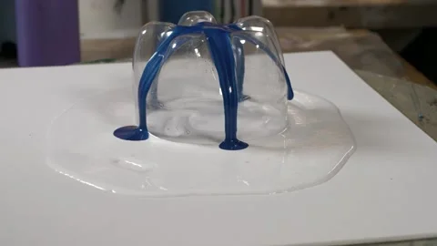Paint flowing on a canvas with a cut bottle. diy art and creation. slow mot.. Video stock 238937013