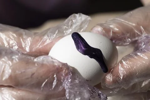 Paint flowing on the egg Stock Photos