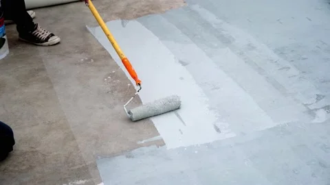 Paint the green floor with a paint roller for waterproof, reinforcing mesh, repa Stock Footage 169442694