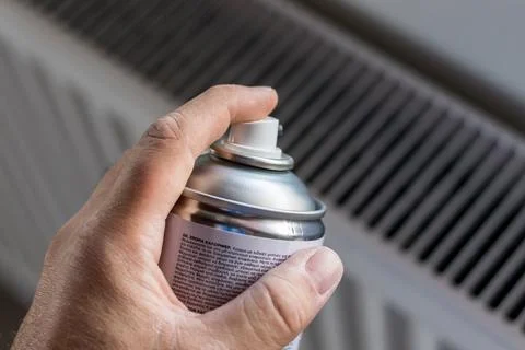 Paint a Heating radiator with spray Stock Photos