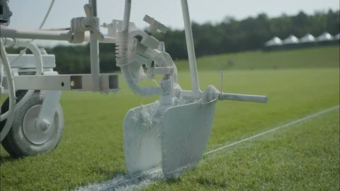 Paint machine spraying white line on football field Stock Footage 105424274
