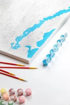 A paint-by-numbers project in progress, featuring blue painted areas on the c Stock Photos