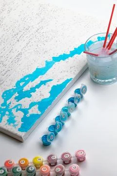 A paint-by-numbers project in progress, featuring blue painted areas on the c Stock Photos